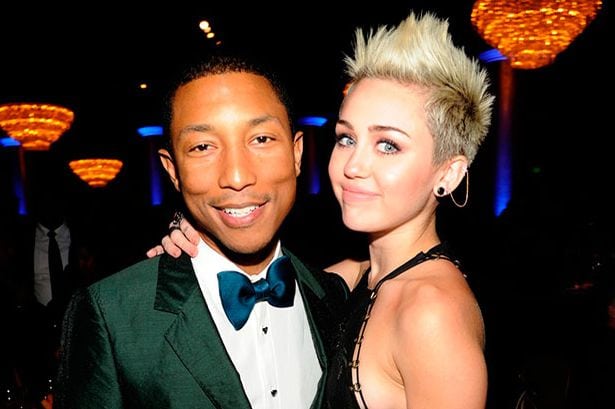 Miley and her brother (presumably from another mother) Pharrell Courtesy of Getty Images